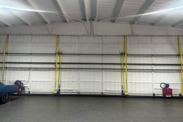 Insulated interior wall of a metal hangar showcasing structural and utility features.