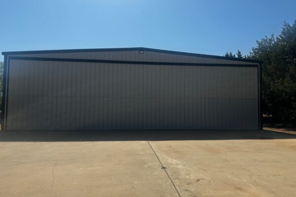 Front view of a custom metal airplane hangar built by Titan Steel Buildings.
