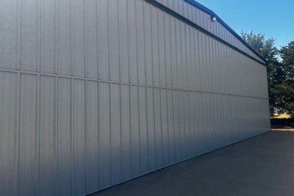 Side angle of a durable metal airplane hangar designed by Titan Steel Buildings.